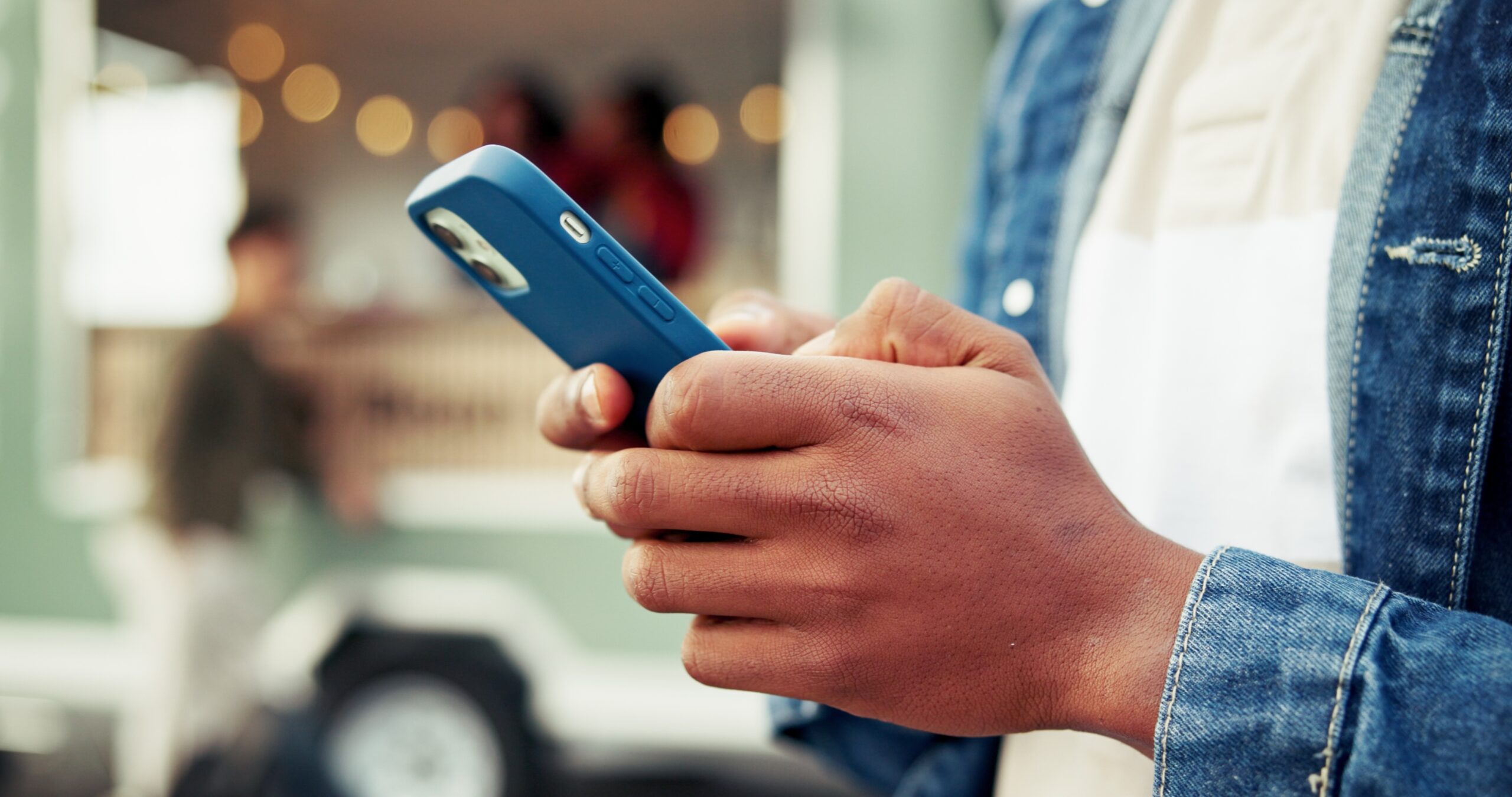 Customer holding a smartphone while researching trends in 2026
